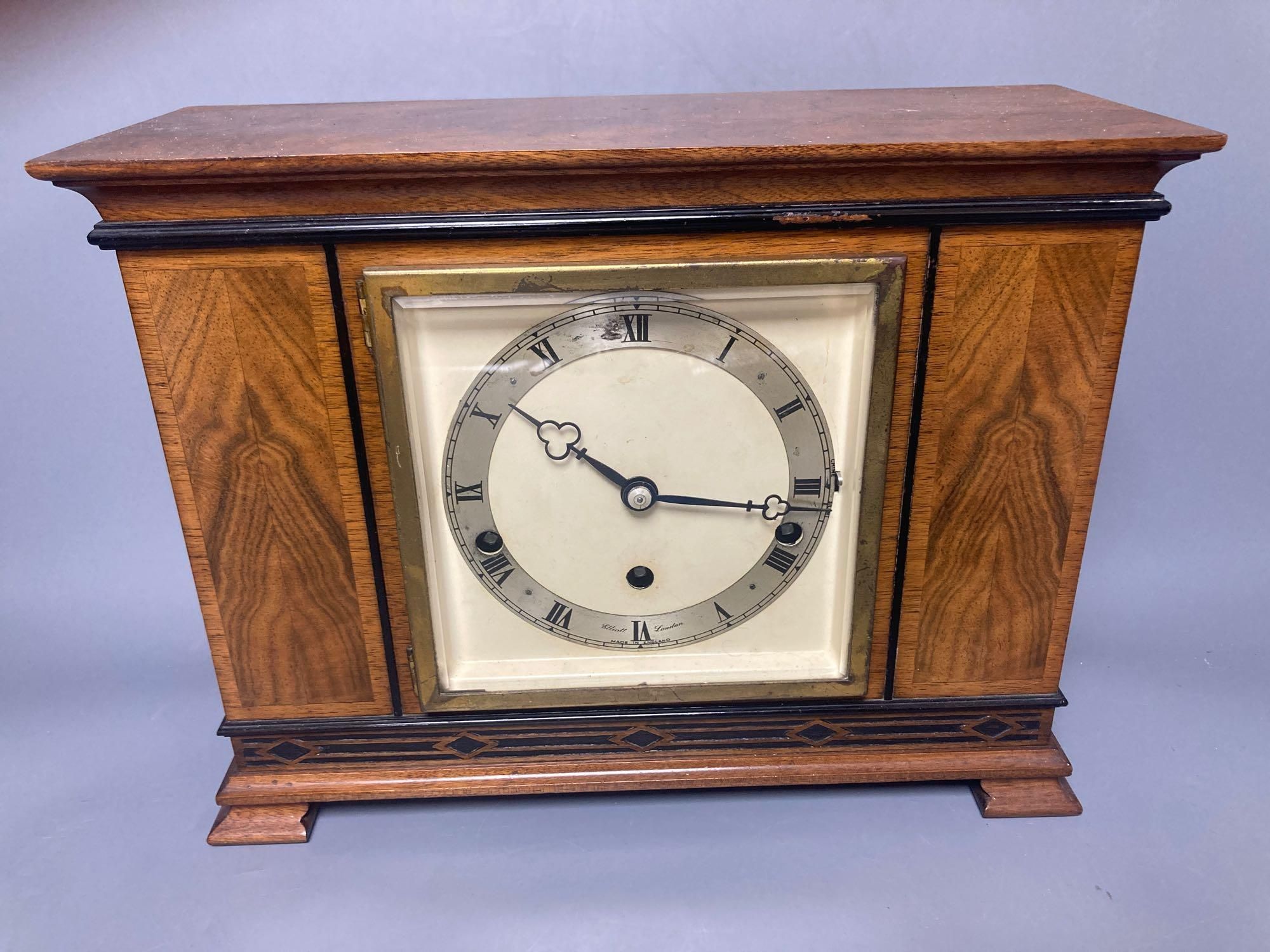 A mahogany mantel clock with ebonised decoration, by Elliott of London, width 33cm, height 25cm